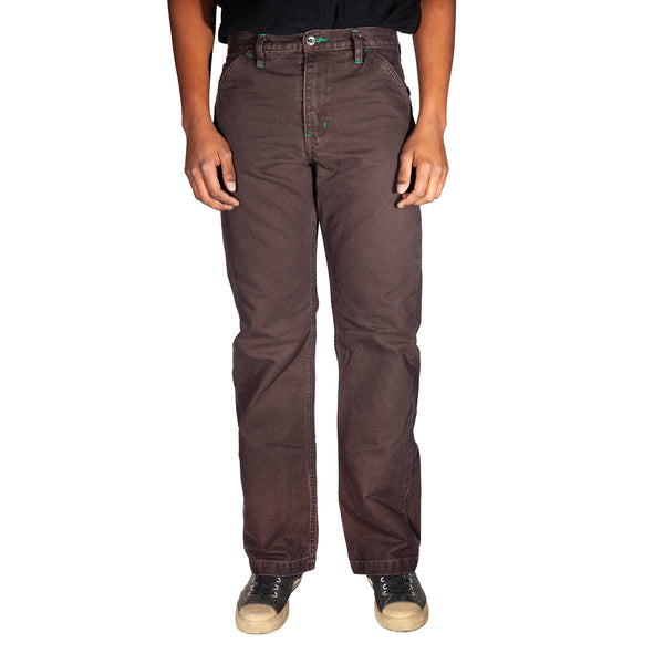 Brown pants worn by a person on a white background