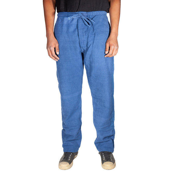 Blue pants worn by a person on a white background