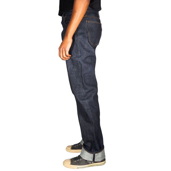 Person wearing dark blue jeans on a white background