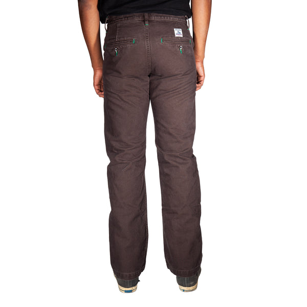 Brown pants worn by a person on a white background