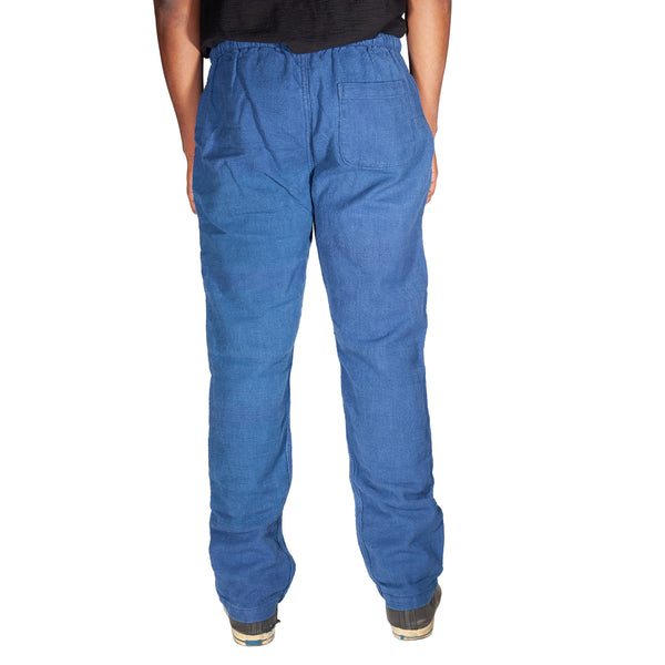 Blue pants worn by a person on a white background