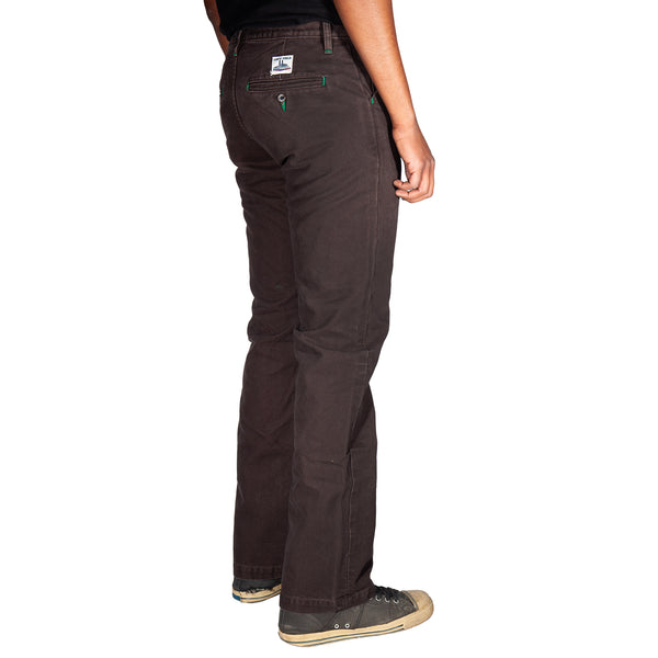 Dark brown pants worn by a person on a white background