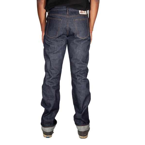 Person wearing dark blue jeans on a white background