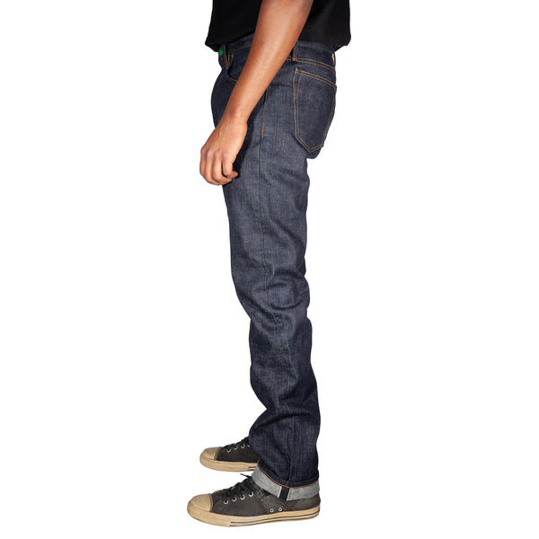 Person wearing dark blue jeans on a white background