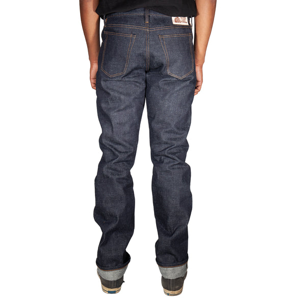Person wearing dark blue jeans on a white background