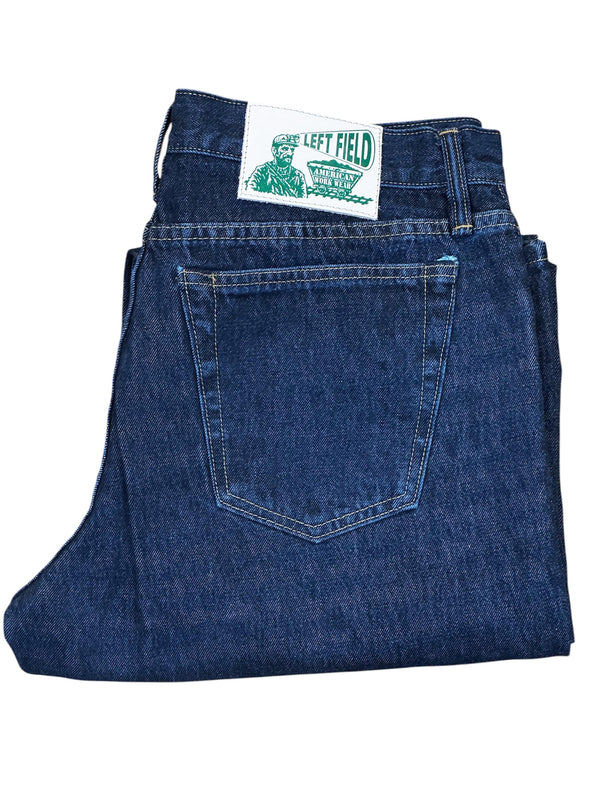 Folded blue jeans with a brand label on a white background
