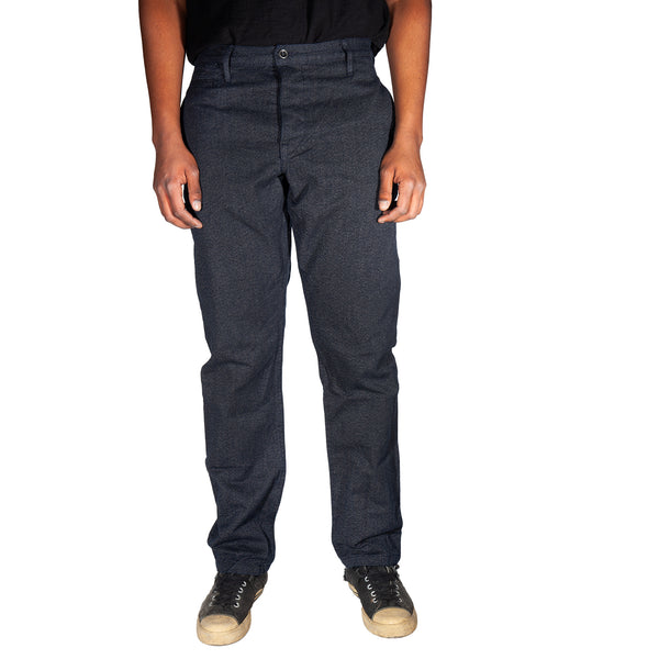 Dark gray pants worn by a person on a white background