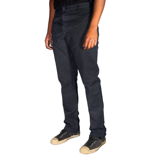 Person wearing dark jeans and black sneakers on a white background