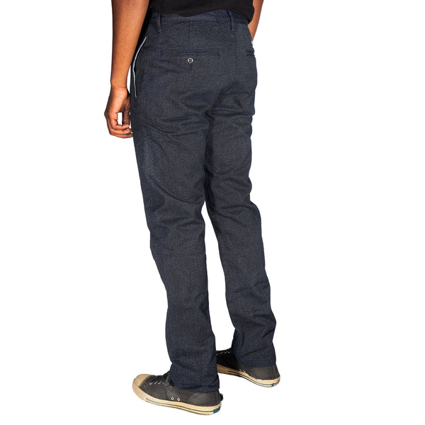 Dark gray pants worn by a person on a white background