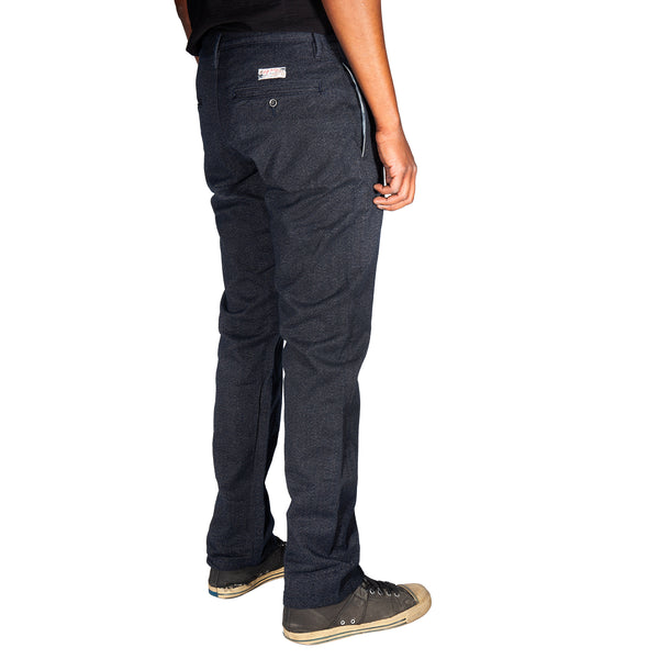 Person wearing dark blue pants on a white background