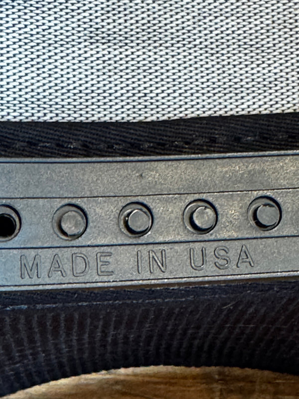 Close-up of a tire tread with 'MADE IN USA' engraving on a textured background.