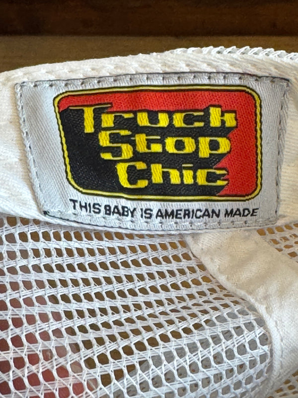 Close-up of a 'Levi's Made & Crafted' label on a white mesh garment.