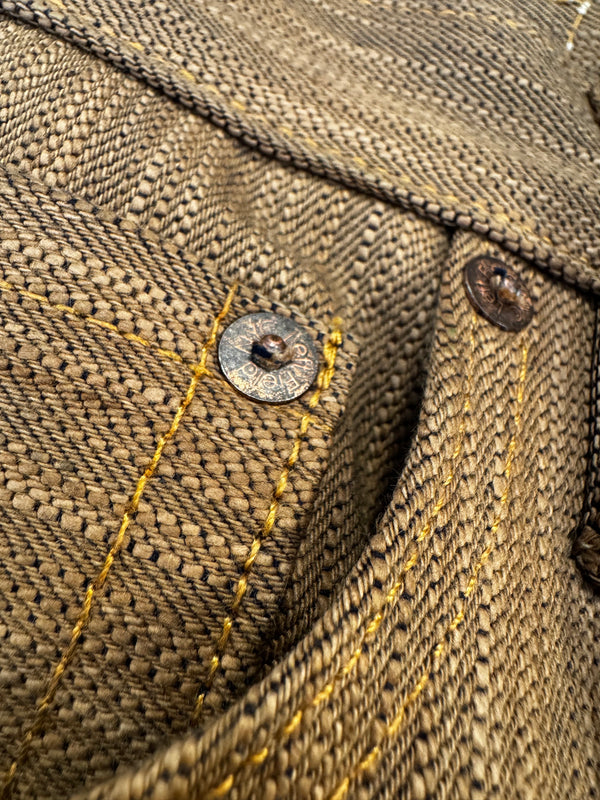 Close-up of a textured fabric with buttons and stitching details