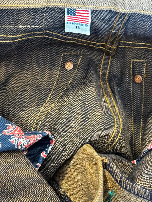 Close-up of a denim jacket with a brand label and floral lining peeking out.