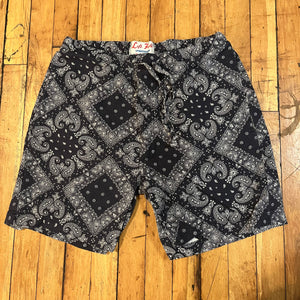 Black and white patterned shorts on a wooden floor
