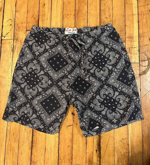 Black and white patterned shorts on a wooden floor
