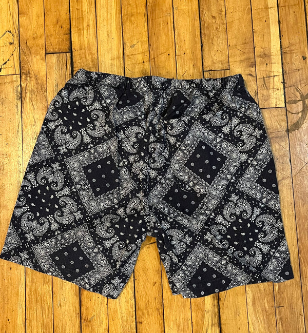 Black and white patterned shorts on a wooden floor