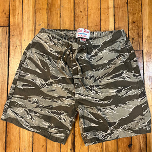 Camouflage shorts on a wooden surface