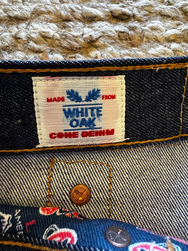Close-up of a denim label on a garment with 'White Oak Denim' branding.