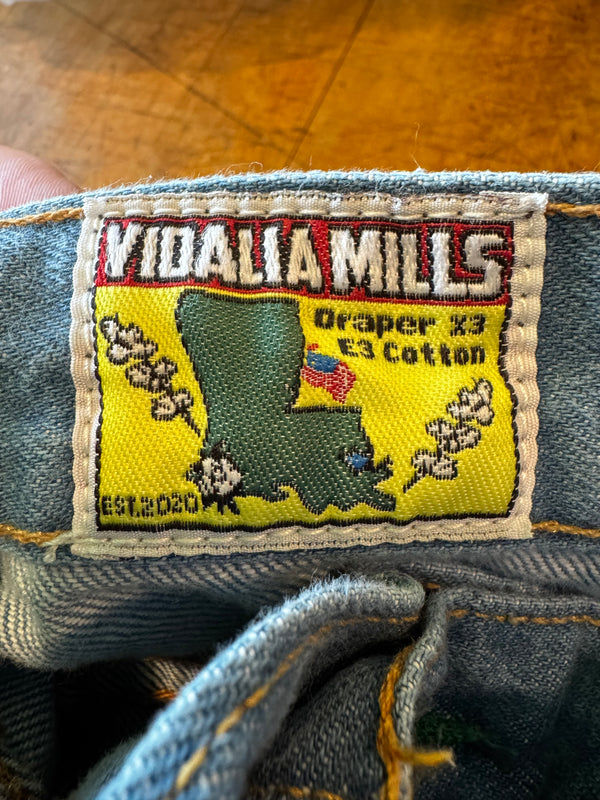 Close-up of a Ksubi jeans label on denim fabric.