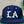 Navy blue cap with 'LA' logo on a green surface