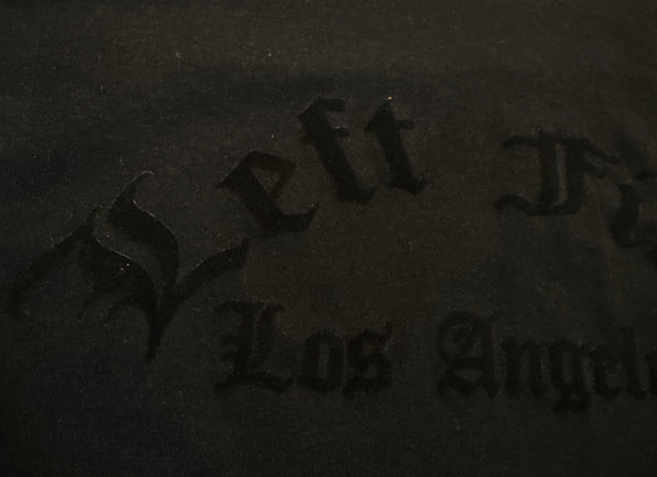 Text 'As Left to Los Angeles' embossed on a dark surface