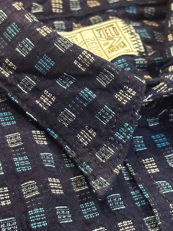 Close-up of a patterned fabric with a visible brand label.