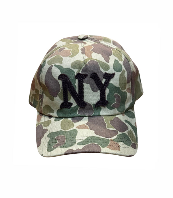 A baseball cap with a green, brown, and beige camouflage pattern, featuring a black embroidered 'NY' logo on the front, set against a plain white background.