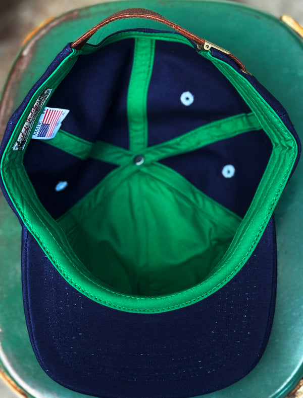 Close-up of a blue and green cap with a visible brand label.