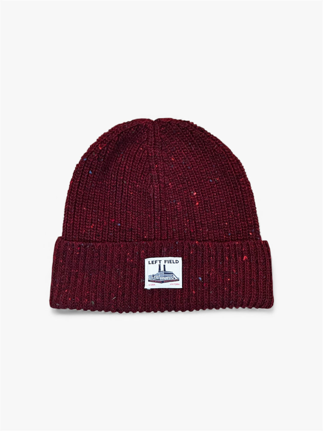 Maroon knit beanie with a label on a light gray background