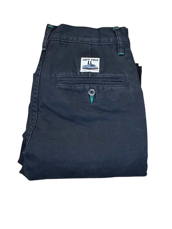 Folded black pants with a brand label on a white background
