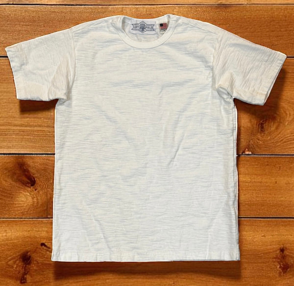 White t-shirt on a wooden surface