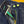 Close-up of a blue denim jacket with a green zipper and gold buttons.